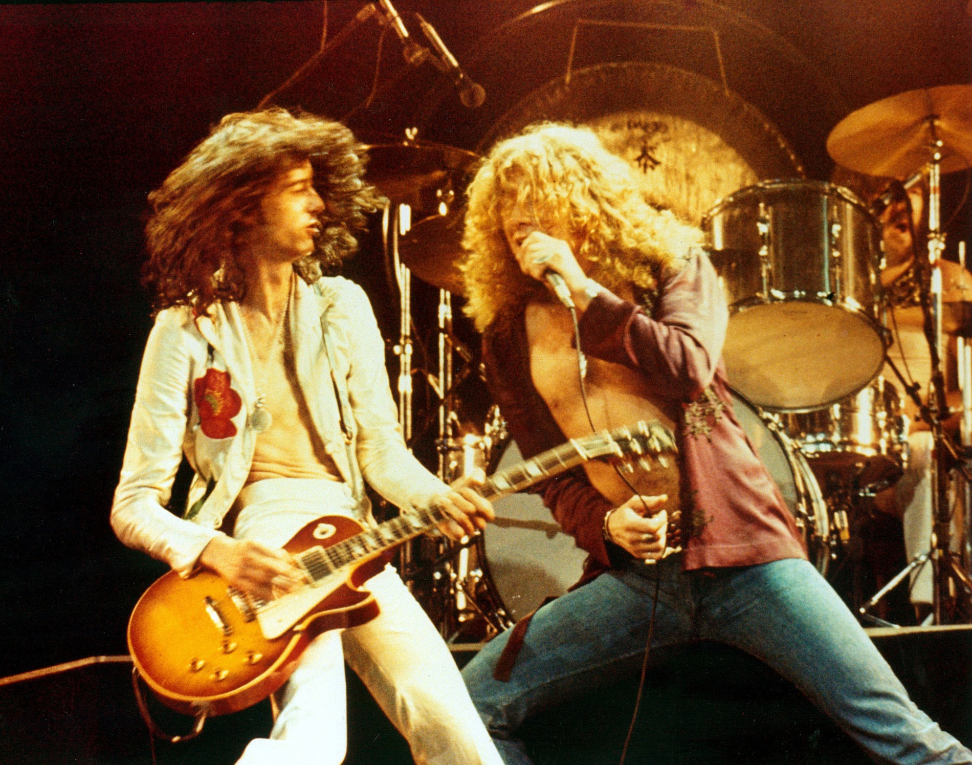 123 ROCK | Led Zeppelin | Robert Plant (Robert Anthony Plant) - August 20, 1948 - West Bromwich, Staffordshire, England, United Kingdom - Lead Vocals, Backing Vocals, Acoustic Guitar, Bass Guitar, Tambourine, Harmonica (1968 - 1980) (1994) (1998), Jimmy Page (James Patrick Page) - January 9, 1944 - Heston, Middlesex, London, England, United Kingdom - Electric Guitars, Rhythm Guitar, Acoustic Guitar, Twelve-string Guitar, Pedal Steel Guitars, Lap Steel Guitar, Slide Guitar, Double Neck Guitar with Six-String and Twelve-String, Bass Guitar, Mandolin, Theremin, Banjo, Dulcimer, The Gizmo, Backing Vocals (1968 - 1980) (1994) (1998), John Paul Jones (John Baldwin) - January 3, 1946 - Sidcup, Kent, London, England, United Kingdom - Bass Guitar, Guitar, Mandolin, Double Bass, Keyboards, Organ, Piano, Acoustic Piano, Electric Piano, Mellotron, Synthesizer, VCS3 Synthesizer, Hohner Clavinet, Hammond Organ, Harpsichord, Moog Synthesizer, Bass Guitar Effects Unit, Recorder, Backing Vocals (1968 - 1980), John Bonham (John Henry Bonham) (Also called : Bonzo, The Beast, Powerhouse) - May 31, 1948 - Redditch, Worcestershire, England, United Kingdom - Drums, Percussions, Timpani, Backing Vocals (1968 - 1980) | Genre : Hard Rock, Heavy Metal, Blues Rock, Folk Rock, Progressive Rock, Psychedelic Rock | Live | Concert | Photo | 36 | Photograph
