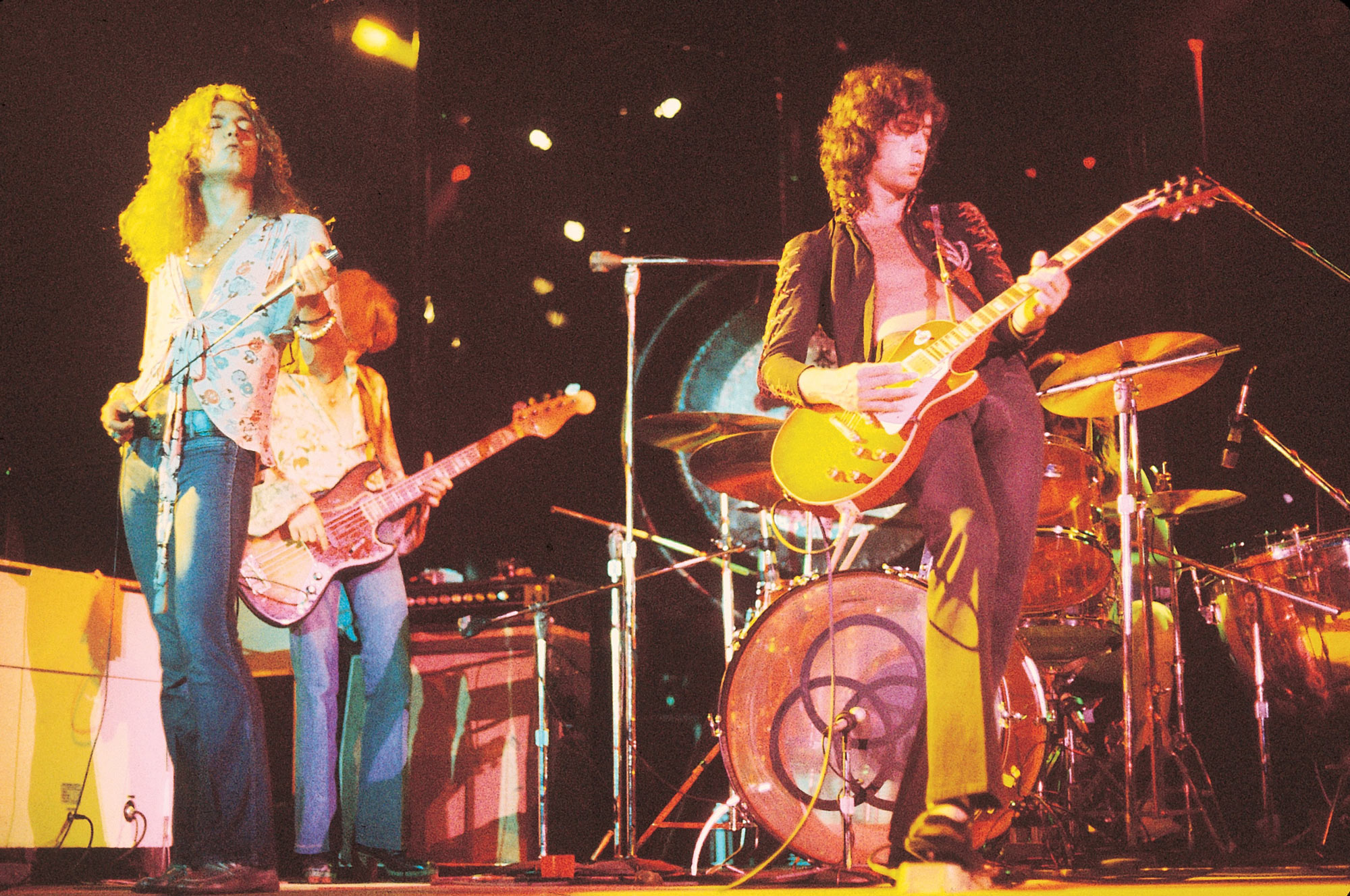 123 ROCK | Led Zeppelin | Robert Plant (Robert Anthony Plant) - August 20, 1948 - West Bromwich, Staffordshire, England, United Kingdom - Lead Vocals, Backing Vocals, Acoustic Guitar, Bass Guitar, Tambourine, Harmonica (1968 - 1980) (1994) (1998), Jimmy Page (James Patrick Page) - January 9, 1944 - Heston, Middlesex, London, England, United Kingdom - Electric Guitars, Rhythm Guitar, Acoustic Guitar, Twelve-string Guitar, Pedal Steel Guitars, Lap Steel Guitar, Slide Guitar, Double Neck Guitar with Six-String and Twelve-String, Bass Guitar, Mandolin, Theremin, Banjo, Dulcimer, The Gizmo, Backing Vocals (1968 - 1980) (1994) (1998), John Paul Jones (John Baldwin) - January 3, 1946 - Sidcup, Kent, London, England, United Kingdom - Bass Guitar, Guitar, Mandolin, Double Bass, Keyboards, Organ, Piano, Acoustic Piano, Electric Piano, Mellotron, Synthesizer, VCS3 Synthesizer, Hohner Clavinet, Hammond Organ, Harpsichord, Moog Synthesizer, Bass Guitar Effects Unit, Recorder, Backing Vocals (1968 - 1980), John Bonham (John Henry Bonham) (Also called : Bonzo, The Beast, Powerhouse) - May 31, 1948 - Redditch, Worcestershire, England, United Kingdom - Drums, Percussions, Timpani, Backing Vocals (1968 - 1980) | Genre : Hard Rock, Heavy Metal, Blues Rock, Folk Rock, Progressive Rock, Psychedelic Rock | Live | Concert | Photo | 37 | Photograph